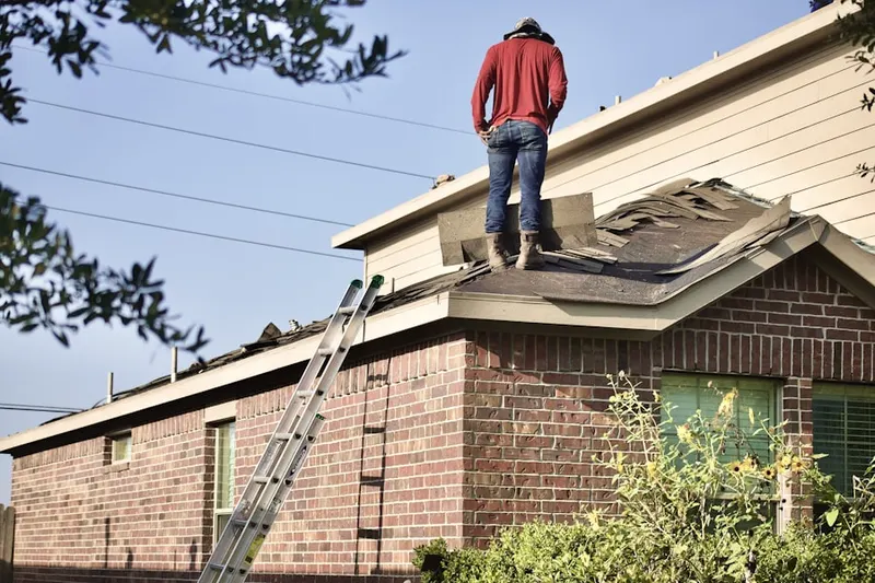 Professional roofer working on a residential roof in Sandy Spring